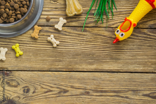 Dog food selection on wooden background with copy space, top view