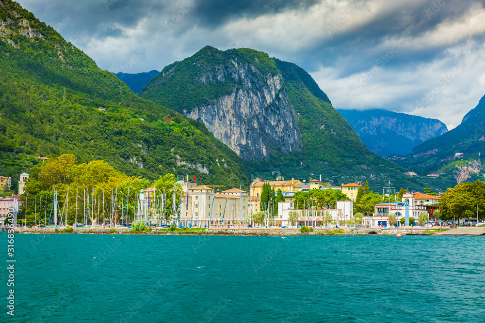 Riva del Garda harbor with boats located at the Garda lake.