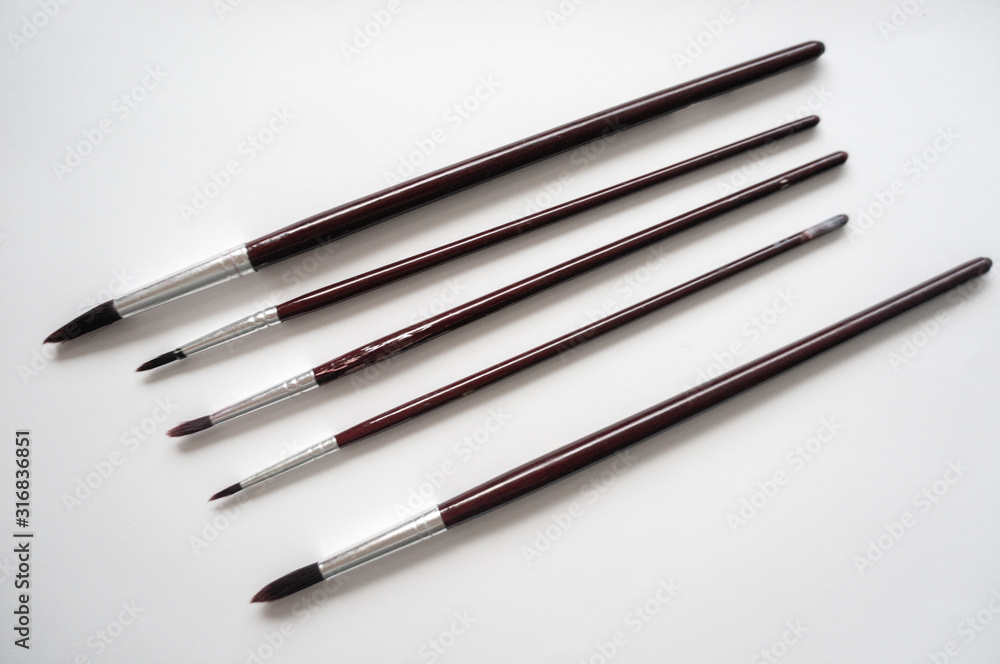 Watercolor brushes arranged diagonally on white background Watercolor brushes arranged diagonally on white background