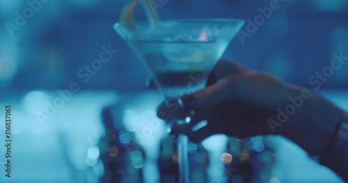 Slow motion video of attractive woman drinking cocktail in the night club