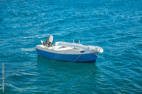 small fishing blue white boat in turquoise sea © Sergey
