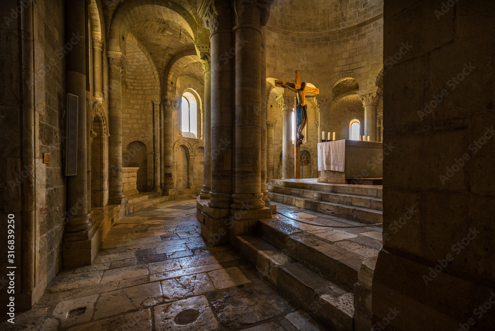 internal of abbazia di sant'antimo in italyin tuscany with columns geometric windows church religion low light