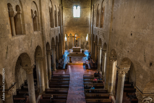 internal of abbazia di sant antimo in italyin tuscany with columns geometric windows church religion low light