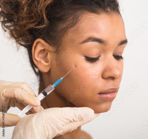 African-american woman making plastic surgery procedure, crop