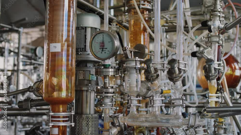 Chemical equipment for mixing on factory. Laboratory flasks with liquid reagents, glass tubes, valves, cables, pressure meters. Chemical, pharmaceutical and biotechnology industry. Chemical equipment for mixing on factory. Laboratory flasks with liquid reagents, glass tubes, valves, cables, pressure meters. Chemical, pharmaceutical and biotechnology industry.