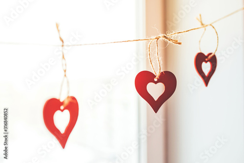 Decoration for Valentine's Day with ornaments in the form of hearts on a branch.