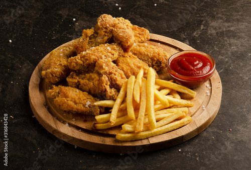 Fried chicken wings, french fries and ketchup sauce