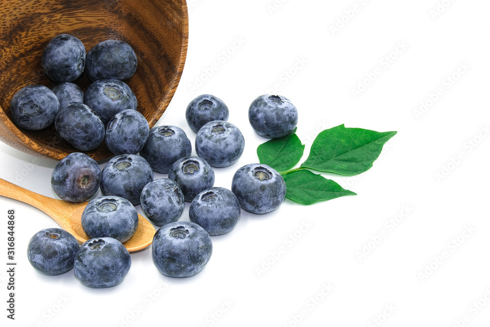group of blueberry fresh fruit on wooden bowl spoon with green leave. Isolated on white background group of blueberry fresh fruit on wooden bowl spoon with green leave. Isolated on white background