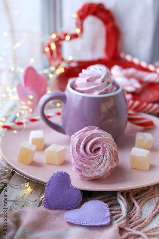 Cup of coffee with meringues and marshmallows, Turkish delight on a plate, hearts, illumination, against the background of a window, homeliness, Valentine's day