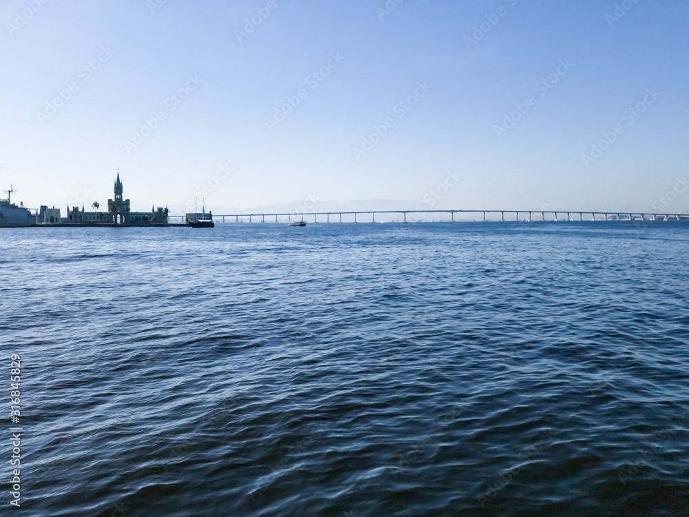 Historical building in Ilha Fiscal, besides the famous Rio de Janeiro Niteroi Bridge, seen from inside Guanabara Bay, Historical building in Ilha Fiscal, besides the famous Rio de Janeiro Niteroi Bridge, seen from inside Guanabara Bay,
