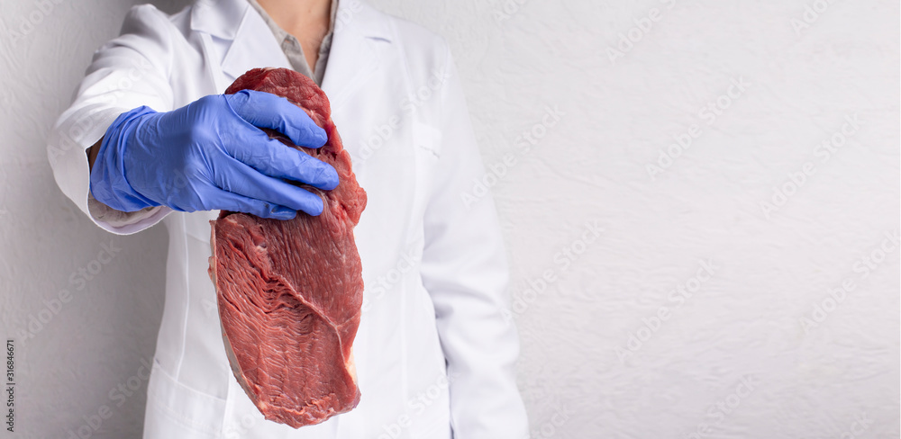 Fototapeta premium Scientist holding raw fresh meat in outstretched hand