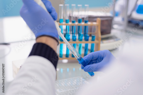 Young female Laboratory scientist working at lab with test tubes, test or research in clinical laboratory.Science, chemistry, biology, medicine and people concept.