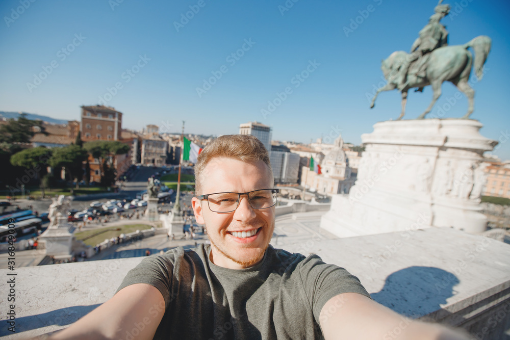 Happy male tourist taking selfie photo on background Venice Square in Rome Italy, blue sky. Travel concept