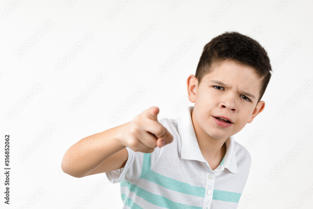 Cute little boy in striped t-shirt pointing camera on white background. child pointing at you. Cute little boy in striped t-shirt pointing camera on white background. child pointing at you.