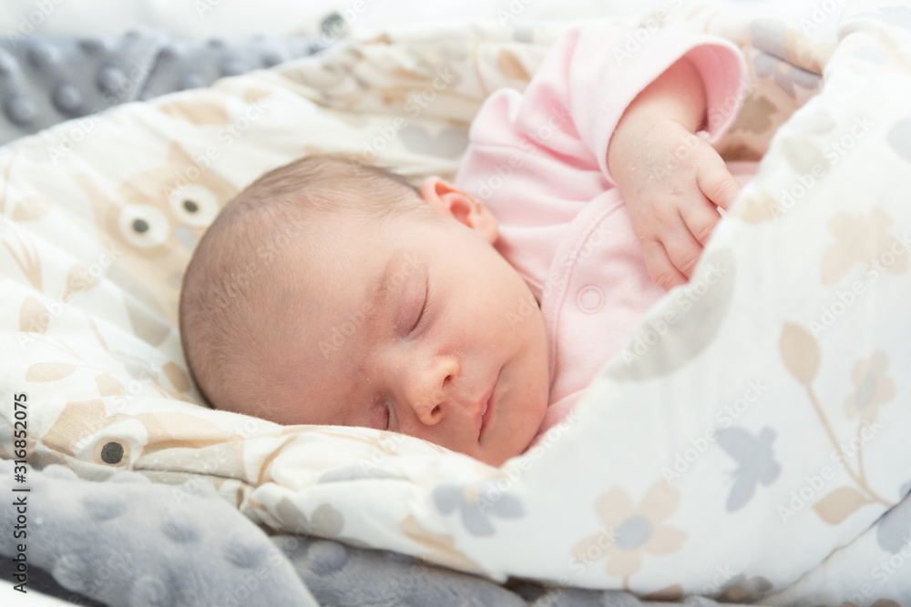 Sleeping newborn baby. Cute little girl one week old at home. Adorable lying on side covered with blanket. No retouch, newborn dry skin. Sleeping newborn baby. Cute little girl one week old at home. Adorable lying on side covered with blanket. No retouch, newborn dry skin.