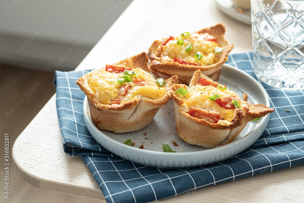 Baked egg, ham, tomato and toast cup for breakfast brunch. Baked egg, ham, tomato and toast cup for breakfast brunch.