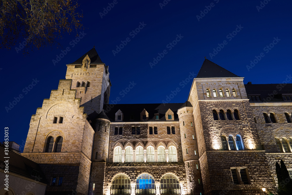Neo-Romanesque Imperial castle with towers at night in Poznan.