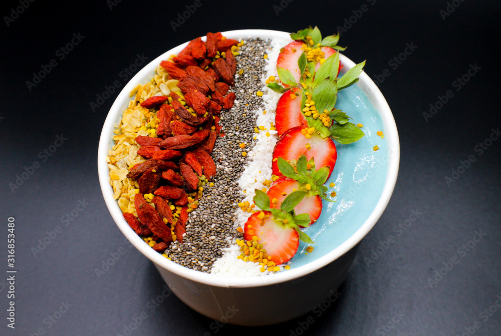 blue smoothie bowl with seeds, fruit, goji berries blue smoothie bowl with seeds, fruit, goji berries