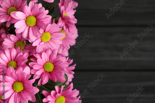 Pink flowers bouquet,over wood background.