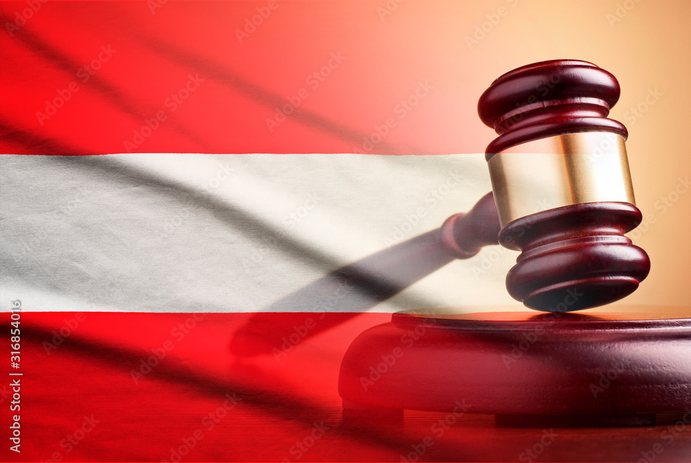 Lawyers wooden gavel over the flag of Austria