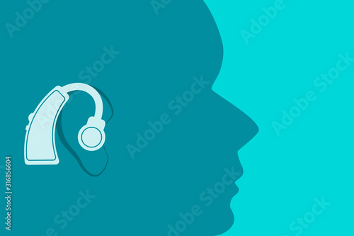 Head with a hearing aid in the ear. Flat design. Vector illustration