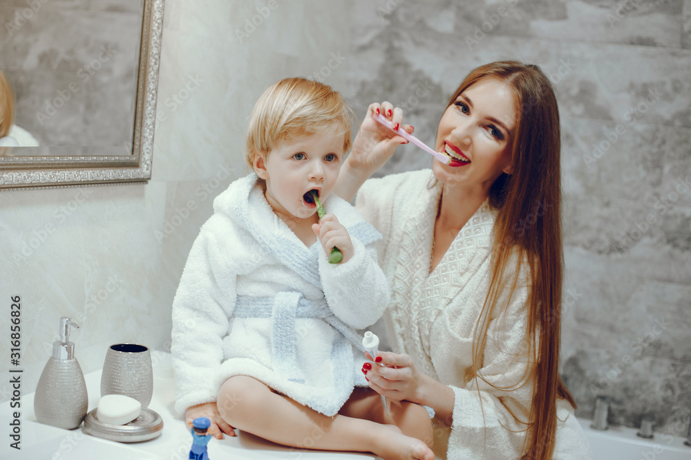 Family in a bathroom. Beautiful mother with little son