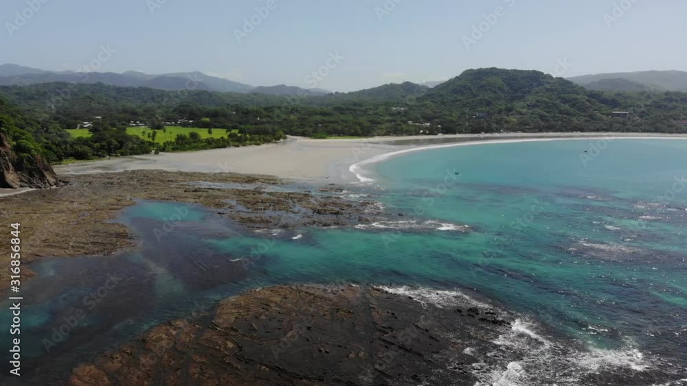 Aerial timelapse shot flying over the rocks at the western side of the bay at Samara. Samara, Costa Rica. Aerial timelapse shot flying over the rocks at the western side of the bay at Samara. Samara, Costa Rica.