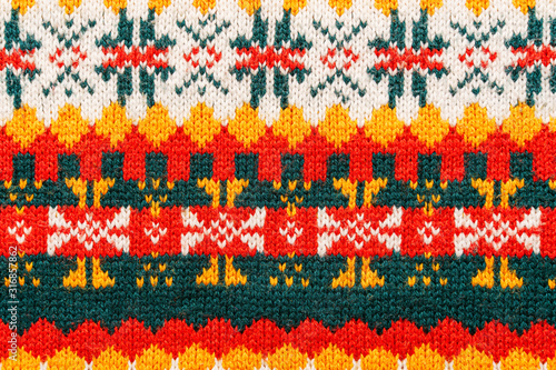 Motley christmas sweater texture with patterns. Colorful knit texture