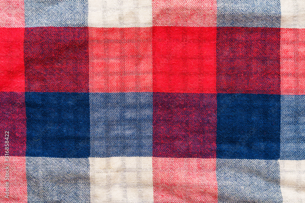 Plaid material texture. Red, blue and white cage clothes background Plaid material texture. Red, blue and white cage clothes background