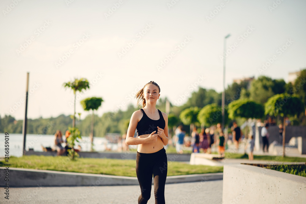 Sports girl. Woman in a summer park. Lady in a sports wear