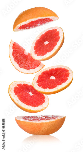 Flying cut grapefruit on white background