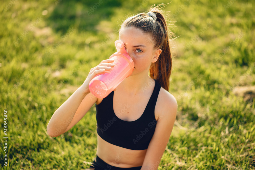 Sports girl. Woman in a summer park. Lady in a sports wear