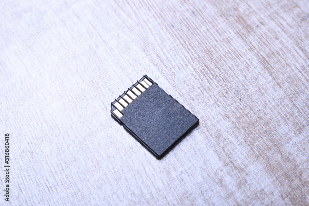Micro SD memory card adapter on the wooden backgroundtable. close up Micro SD memory card adapter on the wooden backgroundtable. close up