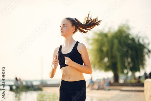 Sports girl. Woman in a summer park. Lady in a sports wear