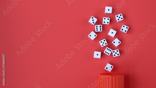 Flat Lay of Dice on a Red Background Spilling From a Red Cup | Game Night