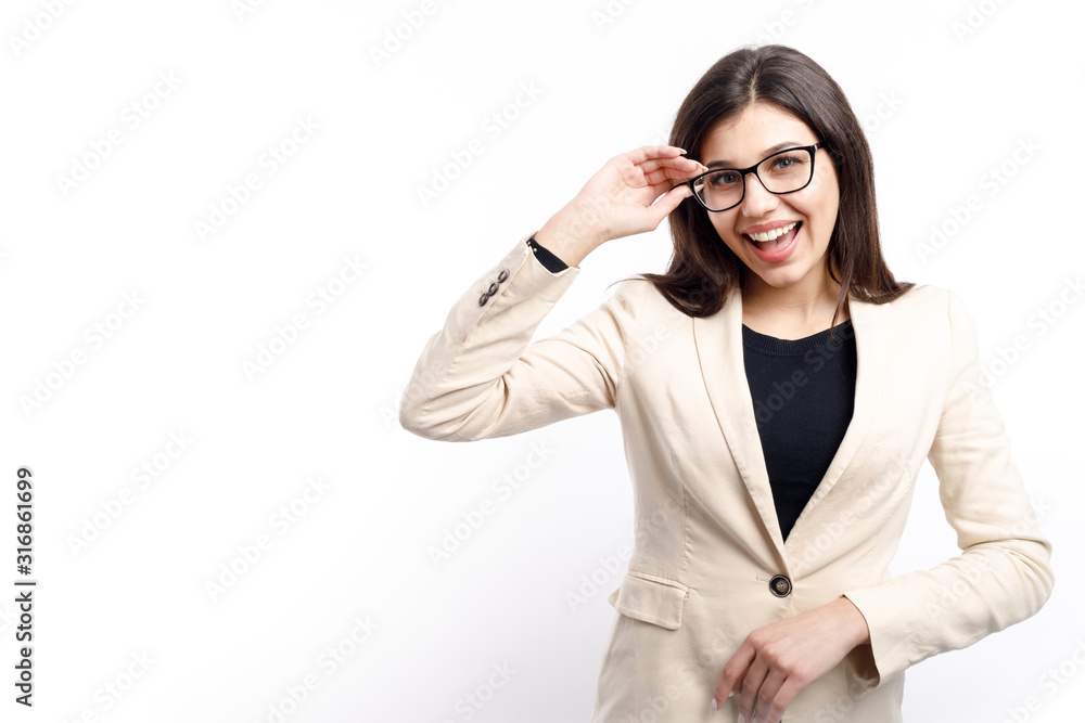 Cheerful smiling businesswoman in cream jacket adjusting glasses isolated white background copyspace Cheerful smiling businesswoman in cream jacket adjusting glasses isolated white background copyspace