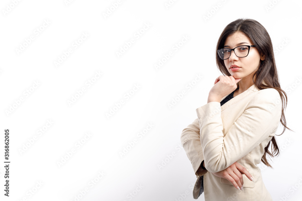 Thoughtful brunette white collar in cream jacket propping her chin isolated white background copyspace Thoughtful brunette white collar in cream jacket propping her chin isolated white background copyspace