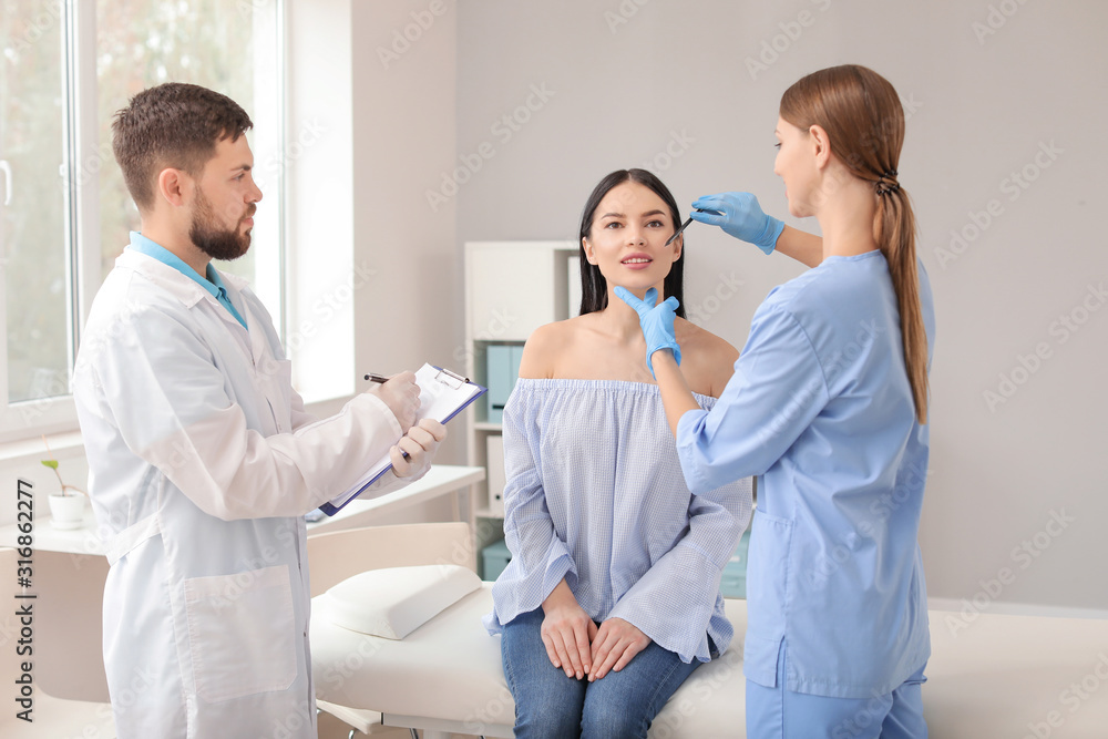 Fototapeta premium Beautiful woman meeting with plastic surgeon in clinic