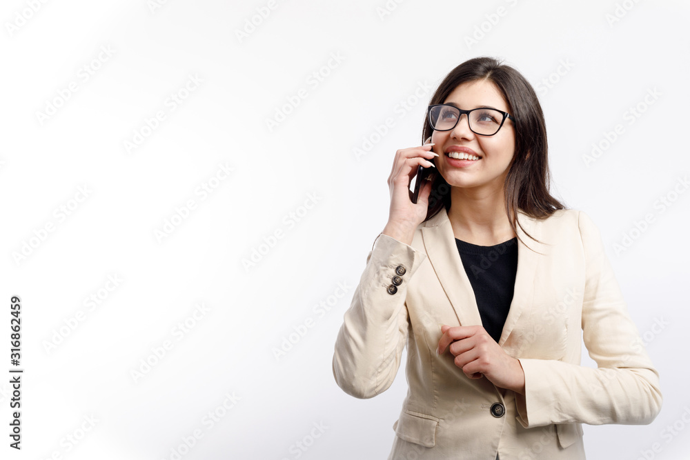 Beautiful stylish businesswoman in cream jacket talking on smartphone isolated white background copyspace Beautiful stylish businesswoman in cream jacket talking on smartphone isolated white background copyspace
