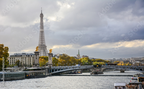 Autumn colorful view of the river Seine in Paris  France  with the Pont Alexandre III and Eiffel Tower in the background with the dramatic blue sky