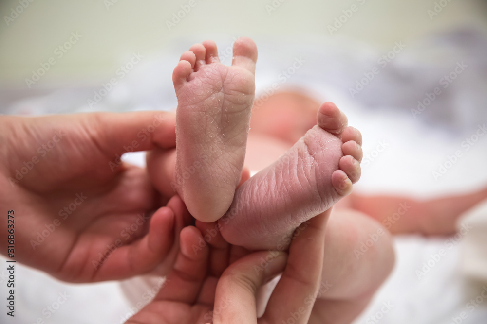 Feet of newborn, small and delicate. Newborn. Feet of newborn, small and delicate. Newborn.