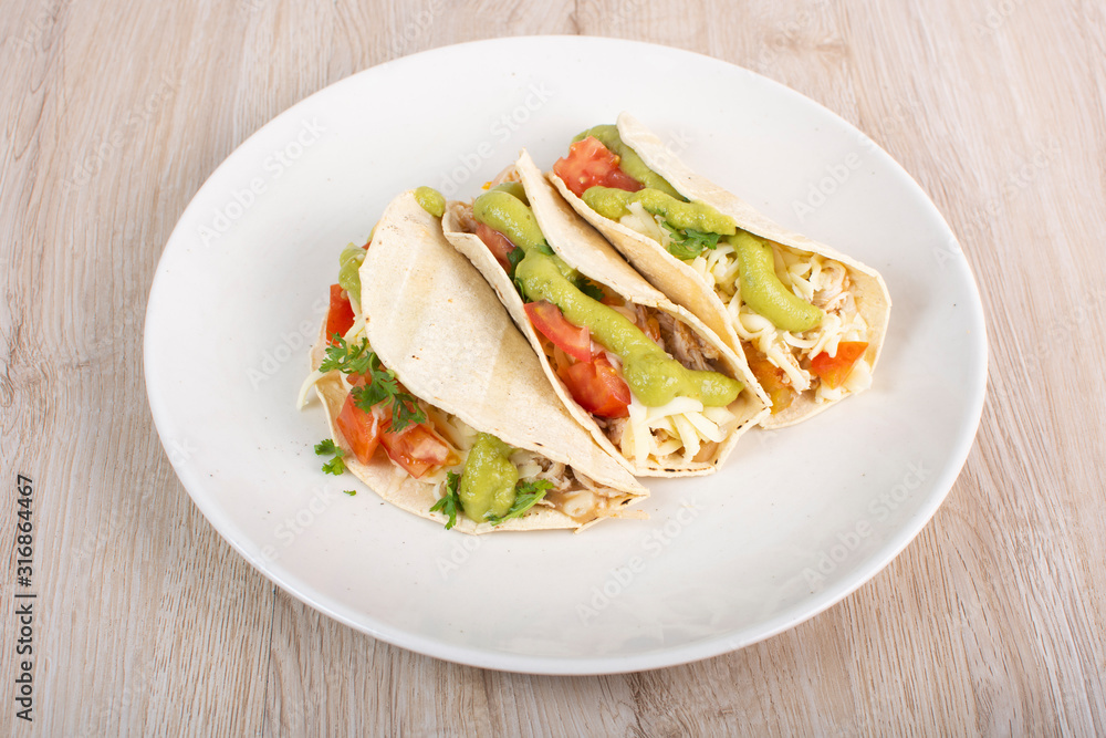 Mexican tacos with chicken, vegetables and guacamole Mexican tacos with chicken, vegetables and guacamole