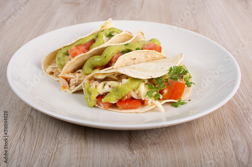 Mexican tacos with chicken, vegetables and guacamole