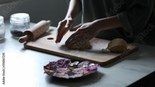 Woman making cookies with Primula petals photo
