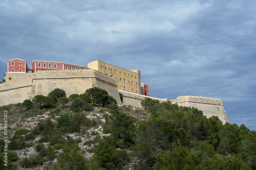 Ibiza Castle at a coast with cloudy sky view, Spain