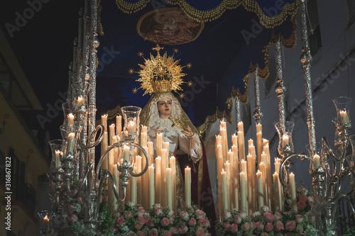 Virgen Maria in procession in Marbella at the holy week , candles an throne at night