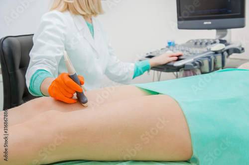 Ultrasound examination of leg veins. Ultrasound vessels at thigh, leg.