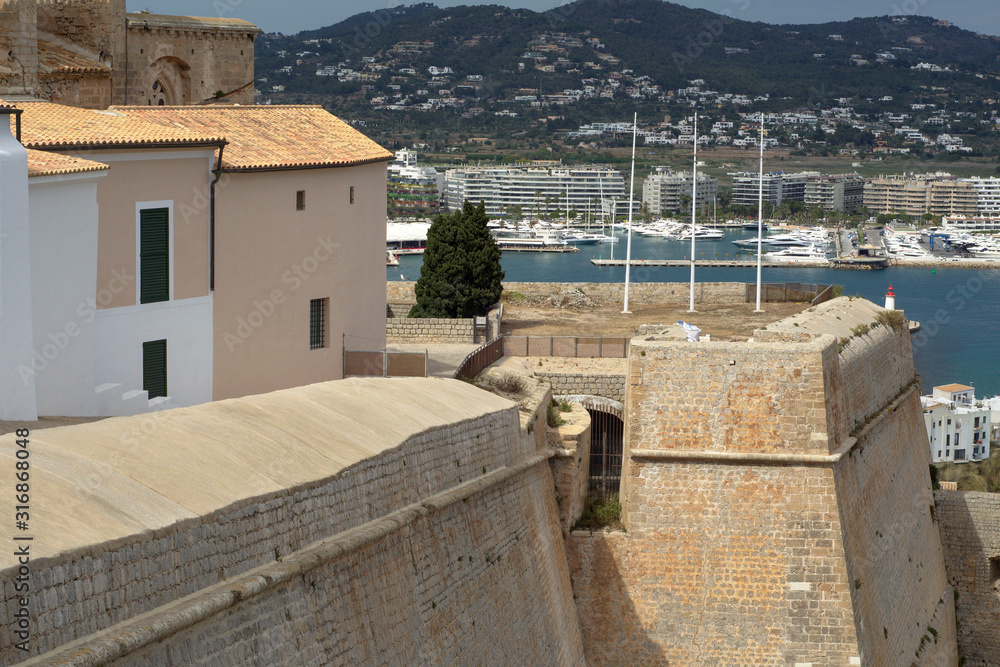Ibiza Castle at a coast with mountain and yachts view, Spain