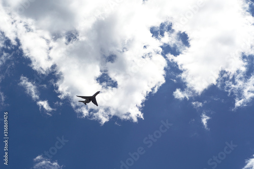 Plane is flying in cloudy sky
