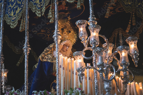 Virgen Maria in procession in Marbella at the holy week , candles an throne at night photo